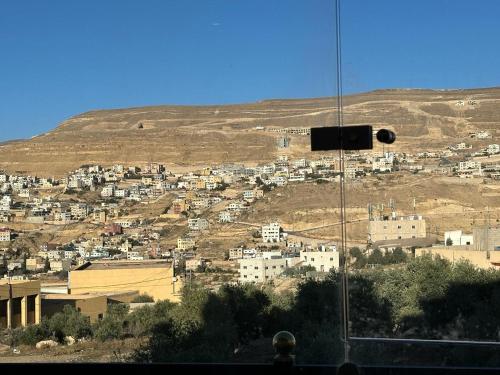 a view of a city with a hill in the background at Amro Petra Apartment in Wadi Musa