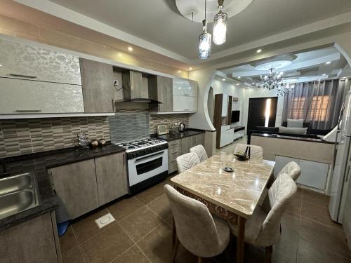a kitchen with a table and chairs in a kitchen at Amro Petra Apartment in Wadi Musa
