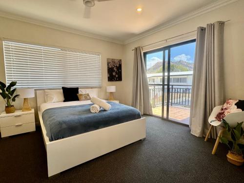 a bedroom with a bed and a large window at Townsville Lighthouse - 3/103 Strand in Townsville