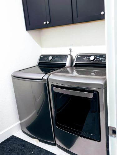 a stainless steel washer and dryer in a kitchen at Modern, Spacious & Relaxing Home in Sparks, NV in Sparks
