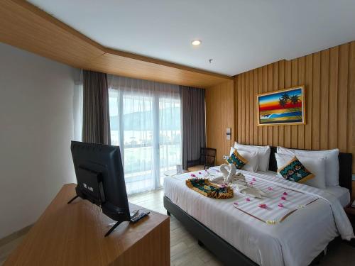 a hotel room with a bed and a television at Raja Hotel Kuta Mandalika Resort & Convention in Kuta Lombok