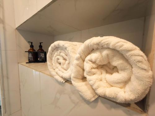 two towels are sitting on a shelf in a bathroom at Raja Hotel Kuta Mandalika Resort & Convention in Kuta Lombok