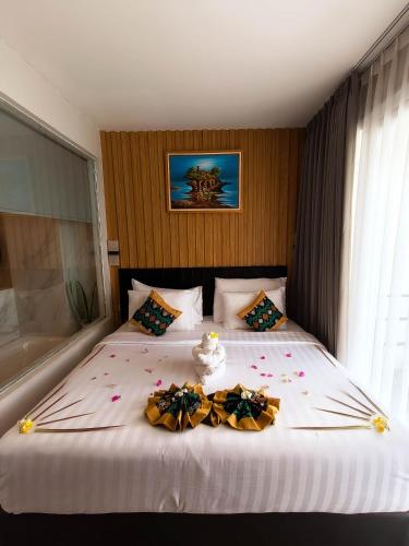 a bedroom with a large bed with flowers on it at Raja Hotel Kuta Mandalika Resort & Convention in Kuta Lombok