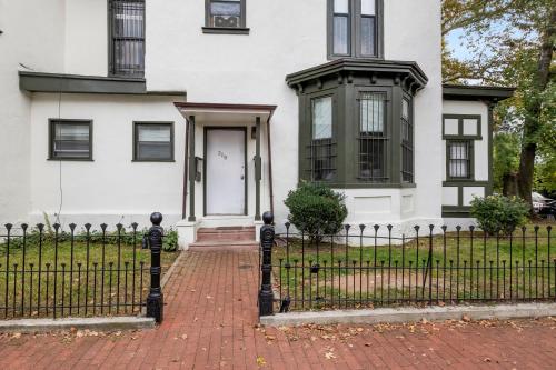 a white house with a wrought iron fence at Charming 1br In Univ City in Philadelphia