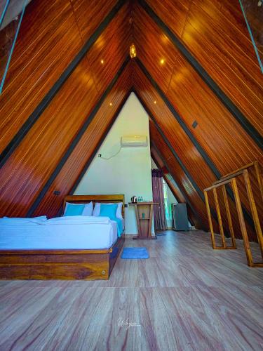 a bedroom with a bed in a wooden roof at Residence Inn in Udawalawe