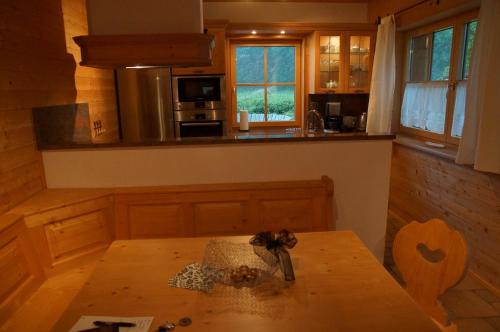 a kitchen with a wooden table and a counter top at W & S Executive Apartments - Hallstatt II in Hallstatt