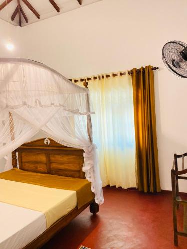 a bedroom with a bed with a canopy at 682 Villa Weligama in Weligama