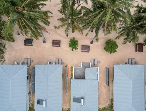 an overhead view of two beach huts and palm trees at Bella Beach Bungalows in Rarotonga