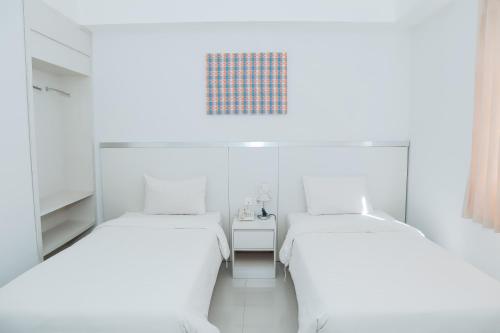Ένα ή περισσότερα κρεβάτια σε δωμάτιο στο Liberta Hotel Grand Sayang Makassar