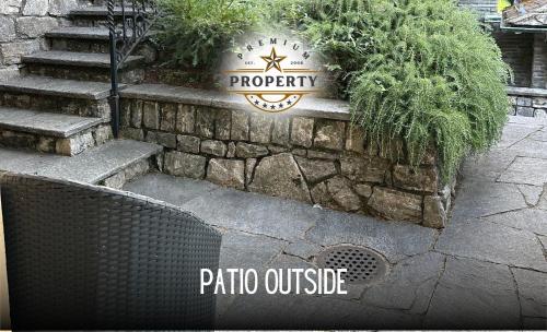 a stone wall with a sign for a patio outside at Magic CHALET near COMO lake, private parking, total privacy I Villa dei Leoni in Morbio Inferiore