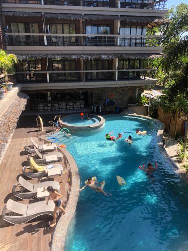 a group of people in a swimming pool in a building at Bugana Beach and Dive Resort in Manlocahoc
