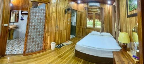 a bedroom with a bed and a walk in shower at Hang Lan Bungalow in Ninh Binh