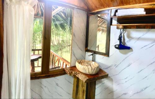 a room with a window and a bowl on a table at Hang Lan Bungalow in Ninh Binh