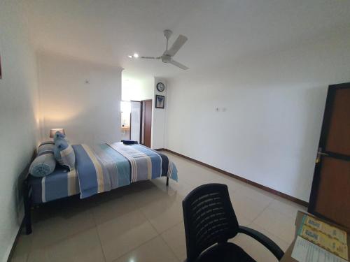 a bedroom with a bed and a ceiling fan at MB Apartments & Hotel Medan in Sunggal