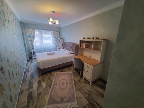 a small bedroom with a bed and a desk at Luxury Apartament Bacovia in Bacău