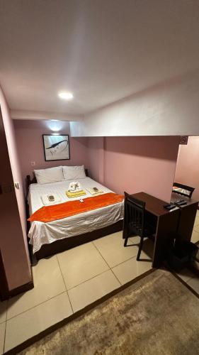 a hotel room with a bed and a desk at Hawaii Lounge in Sihanoukville