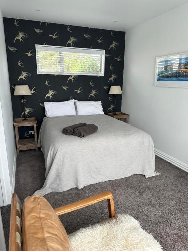 a bedroom with a bed and a window at Guest Suite St Clair Beach in Dunedin