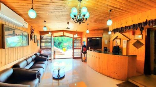 a living room with a couch and a bar at Nigeen Residency Resort , Srinagar in Srinagar