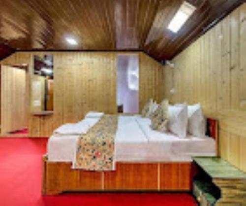 a bedroom with a large bed in a room at Nigeen Residency Resort , Srinagar in Srinagar