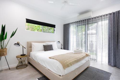 a bedroom with a bed and a large window at Bamboo Villa - Pet friendly luxury Villa next to Botanical Gardens in Edge Hill