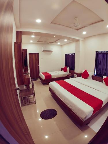 a hotel room with two beds in a room at Hotel Nawanagar Residency in Jamnagar