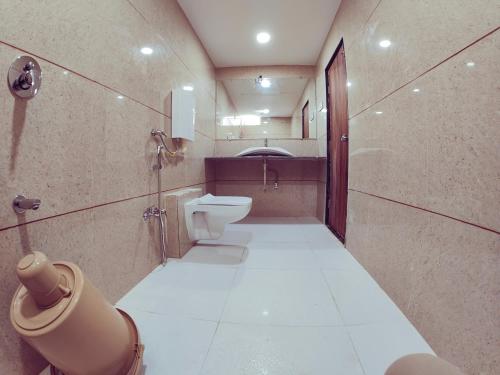 a bathroom with a toilet and a sink at Hotel Nawanagar Residency in Jamnagar