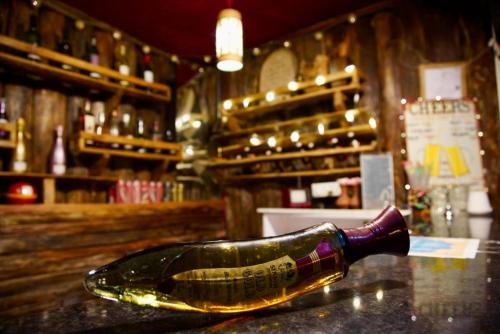 a bottle of wine sitting on a counter in a bar at Backpackers Den (TRC) in Gangtok