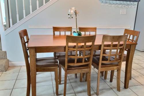 a dining room table with chairs and a wooden table at Paradise Duplex B in Gulf Shores