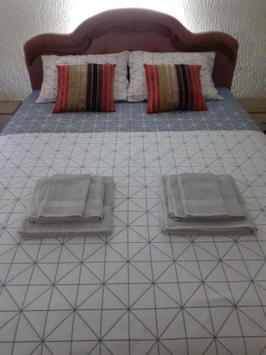 a bed with two pillows on top of it at Zanovetak in Sombor