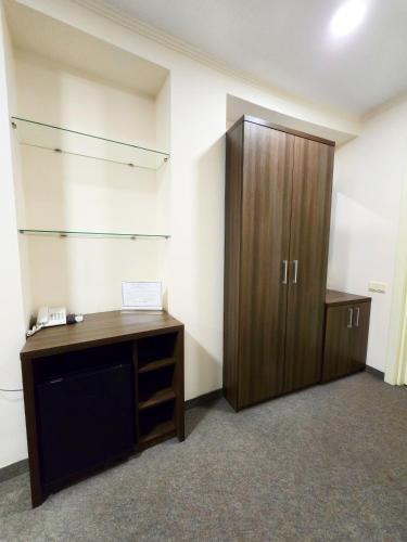an office with a wooden desk and a cabinet at Wellotel Chornomorsk in Chornomorsk