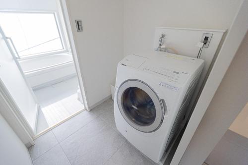 a white washing machine in a room with a window at MARSOL C,S,Beach hotel - Vacation STAY 50047v in Chigasaki
