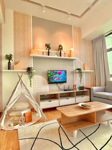 a living room with a tv and a table at imperium residence kuantan in Kuantan