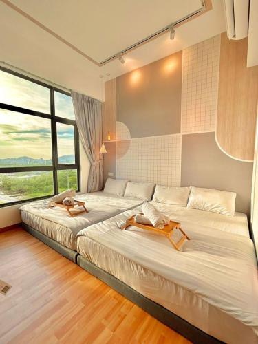 a bedroom with two beds and a large window at imperium residence kuantan in Kuantan