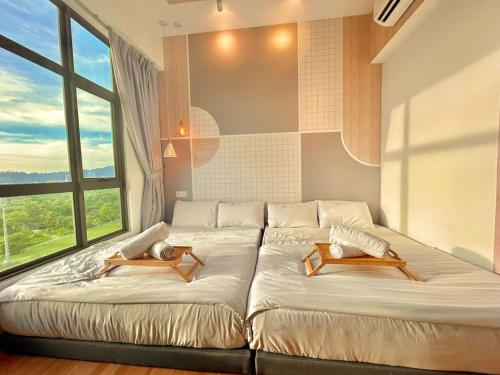 a bedroom with two beds and a large window at imperium residence kuantan in Kuantan