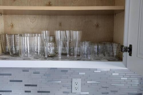 a row of glass jars sitting on a shelf at Canal Park Paradise in Port Saint Lucie
