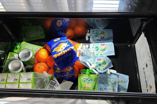 a box full of food with oranges and milk at Canal Park Paradise in Port Saint Lucie