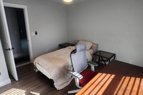 a bedroom with a bed and a desk and a chair at Canal Park Paradise in Port Saint Lucie