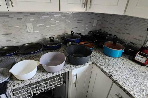 a group of pots and pans on a kitchen counter at Canal Park Paradise in Port Saint Lucie