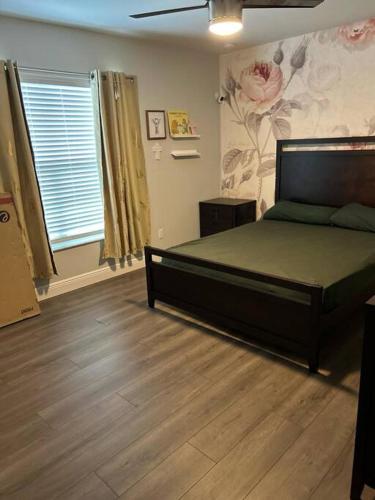 a bedroom with a bed and a flower wall at Canal Park Paradise in Port Saint Lucie
