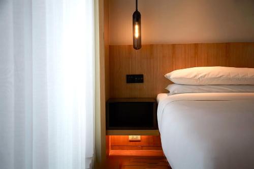 a bedroom with a bed and a tv on a table at Fairfield by Marriott Taichung in Taichung