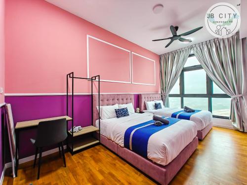 two beds in a room with pink and purple walls at Skudai Paradigm Mall by RR JBcity in Johor Bahru