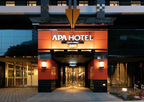 a hotel with a sign on the front of it at APA Hotel Osaka Umeda in Osaka