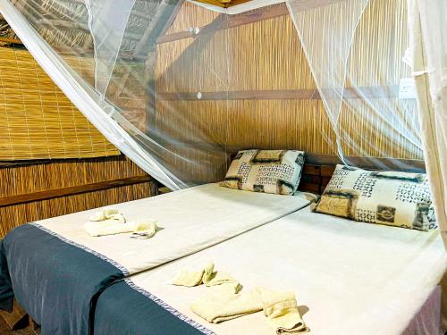 a couple of beds in a boat with towels on them at Nhambavale Lodge in Chidenguele