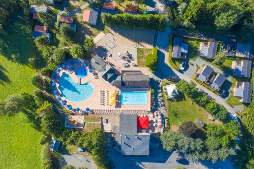 an overhead view of a house with a swimming pool at Camping RCN Belledonne in Le Bourg-dʼOisans