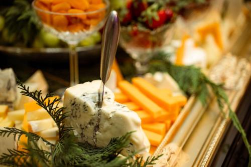 a plate of cheese and vegetables with a spoon at Aria by Brilliant in Zalău