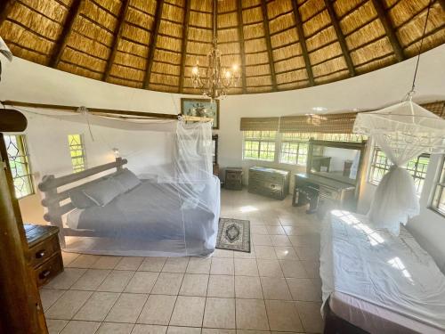 a bedroom with a bed and a mirror in a room at Nhambavale Lodge in Chidenguele