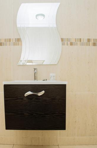 a bathroom with a sink and a mirror at Heavenly Boutique Hotel in Johannesburg