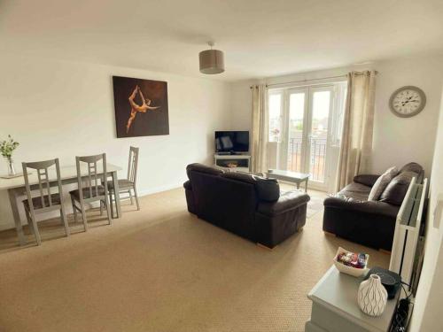 a living room with a couch and a table at Central Retford 2 bed quiet apartment with parking in Retford