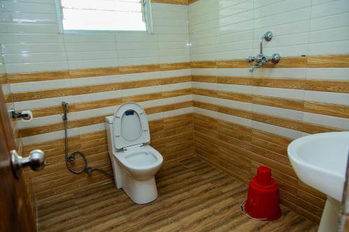 a bathroom with a toilet and a sink at Hotel Everest Regency in Kathmandu