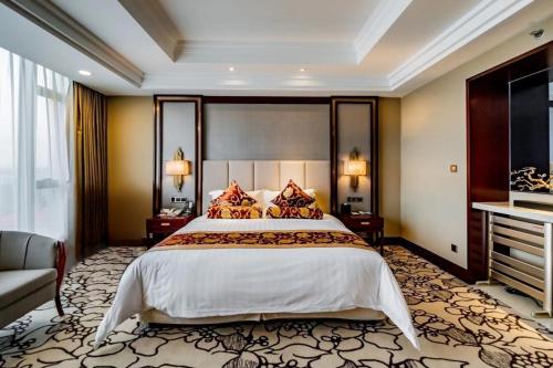 a large bedroom with a large bed and a couch at Soluxe Hotel Guangzhou - Overseas Buyers Registration Service&Canton Fair Free Shuttle Bus 15 Oct to 04 Nov in Guangzhou